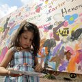 Katheryn Qutob, 4, of Irving, Texas, picks a color for her brush while contributing to the Community...