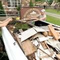 Volunteers Arianna and Eric Gaesswitz of Winslow load debris Saturday into their pickup while helpin...