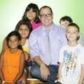 Tyler Clark, middle, youth programs coordinator at The Jones Center, sits Thursday for a portrait wi...