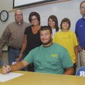 MISSOURI SOUTHERN BOUND - Rogers High pitcher Tanner Kaza sits with his family Friday during a cerem...