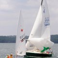 SET SAIL - Tim McMahon, second from left, and son James McMahon make the turn Saturday in front of t...
