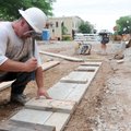 Chris Stanphill of Danny Robinson Construction prepares concrete forms Wednesday to pour curb along ...