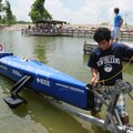 Mario Munoz, with the University of New Orleans solar boat team, loads the team’s boat Sunday at Lak...