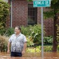 Frank Kuczinski stands in water outside his house in the Palo Verde Addition in Edmond, Okla., after...
