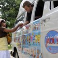 Bernice Alcala, 11, pays for her fudge bar from Brandon Rhine, with Jack’s Ice Cream, on Friday at M...