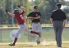 Springdale Harps’ Tyler Turknett, left, is tagged out by Bentonville second baseman Kameron Poole in the bottom of the second inning of Tuesday’s game at Springdale’s Tyson Sports Complex.