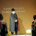 Tom Dillard performs Tuesday on stage as the Arkansas Traveler at the Fayetteville Public Library. L...