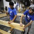 Josh Sutte, right, and Marcus Perry work Tuesday at fabricating walls that will be taken to a Habita...
