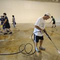 Steve Gordon, wrestling coach for Fayetteville High School, power washes the gym floor Tuesday at th...