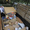 Bill Stewart, left, and Phil Phillips collect cardboard for recycling on Tuesday at Butterfield Trai...
