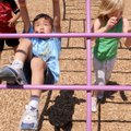 HANGIN’ OUT - Joshua Olsen, 7, hooks a leg over a bar Friday for a backflip at the McKinney Unit Boy...