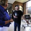 Harold Ripley, right, thanks Susan Chase for his air conditioner Friday at Hillcrest Towers in Fayet...