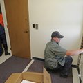 John Kelley, right, installs an air conditioner Friday for Dave Williams, left, at Hillcrest Towers ...