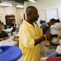Nathan Valdery, a client and volunteer, makes fresh coffee Friday at the Seven Hills Homeless Shelte...