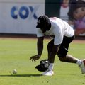 Arkansas wide receiver Carlton Salters scoops up a ground ball hit to right field during drills at t...