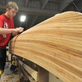 Jacob McCrary, 16, of Rogers, uses a plane to smooth the side of a cedar strip canoe Wednesday, June...