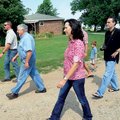  John Robert Hart, center left, leads his family across his Prairie Grove farm Saturday while giving...