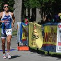 Stephen Ray Stafford of Fayetteville crosses the finish line of the Ozark Valley Triathlon at Lake W...