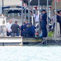 Firefighters work to stop and contain a gasoline spill into Beaver Lake at Prairie Creek Marina on M...