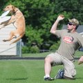 Mike Kittinger of Prairie Village, Kan., practices Saturday with his dog Henry for the freestyle com...
