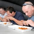 Dan Eddings, from left, Scott Lencowski, Dave Clay and Aaron Beuterbaugh compete in a wing-eating co...
