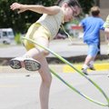 Elisa Flynn, 9, twirls a hoop around her legs Wednesday during Life Source International summer camp...