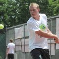 COMMUNITY SERVICE - Cameron Phillips, 17, of Bentonville, returns a tennis ball with a backhand Thur...