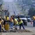 DIDN’T QUITE CROSS THE ROAD - Workers with the Arkansas Highway Transportation Department clean up c...
