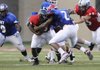The West team’s Courtney Haskell is stopped by the East’s Braylon Mitchell during the Arkansas High School Coaches Association All-Star Game.