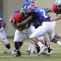 The West team’s Courtney Haskell is stopped by the East’s Braylon Mitchell during the Arkansas High ...