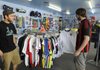 Mason Rial, right, manager of Soccer USA, shows Brad Haj what they have in stock for replica jerseys for the U.S. World Cup soccer team. Haj was looking for USA jerseys to show his support for the home team.
