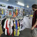 Mason Rial, right, manager of Soccer USA, shows Brad Haj what they have in stock for replica jerseys...