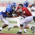 West lineman Travis Eden, right, of Gravette loses his helmet while being blocked by the the East’s ...