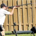 TAKING AIM AT CANCER - Alex Filla breaks a clay bird Friday during the Cancer Challenge Trap Shoot T...