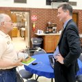 Church member Larry Webster, left, talks about soil-less vegetable planting with Harper on June 14. ...