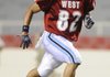  West player Josh McKinney of Springdale Har-Ber runs a play during the Arkansas High School Coaches Association All-Star Game on Friday in Reynolds Razorback Stadium in Fayetteville.
