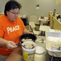 Maudie Schmitt, co-owner of Maudie’s Seafood in Fayetteville, examines the quality of oysters delive...