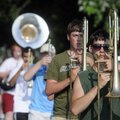 Tim Wilson, right, marches Thursday with the Springdale High School on Emma Avenue in Springdale.