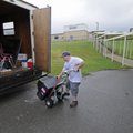 Justin Tate, an employee of the Fayetteville School District, works Monday moving equipment and furn...