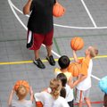 Former Arkansas University Razorback Corey Beck teaches basketball fundamentals Monday to a group of...