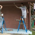 Austin Woody, right, and Andrew Graves, members of the Bentonville Church of Christ youth group, pai...