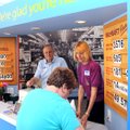 Howard Moore, left, Walmart Visitor Center on West Central coordinator, and manager Boo Randolph hel...