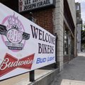 A banner beckons bikers to a Dickson Street night spot in Fayetteville on Tuesday in anticipation of...
