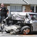 Springdale police officer Dustin Treat walks through the scene of a three-vehicle accident Tuesday a...