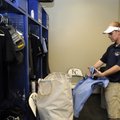 Danny Helmer, stadium operations/clubhouse manager for the Northwest Arkansas Naturals, prepares the...