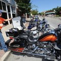 MOTORCYCLE MAMA - Stacey Robinett of Springfield, Mo., gets her camera Thursday from the tour pack o...