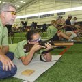 Shooting coach W.B. Merritt of Douglas, Ga., works Thursday with shooter Phaedra Vickers during prac...