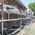 Workers build a brick wall Thursday to improve a series of classrooms at Springdale High School. Mon...