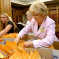 Jeannie Burlsworth (at right) and Brean Schoultz, both with Secure Arkansas, sort through boxes of s...