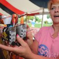  Sandra Dartanian of Bentonville shows a robot dog firework Wednesday at the Rainbow Fireworks stand...